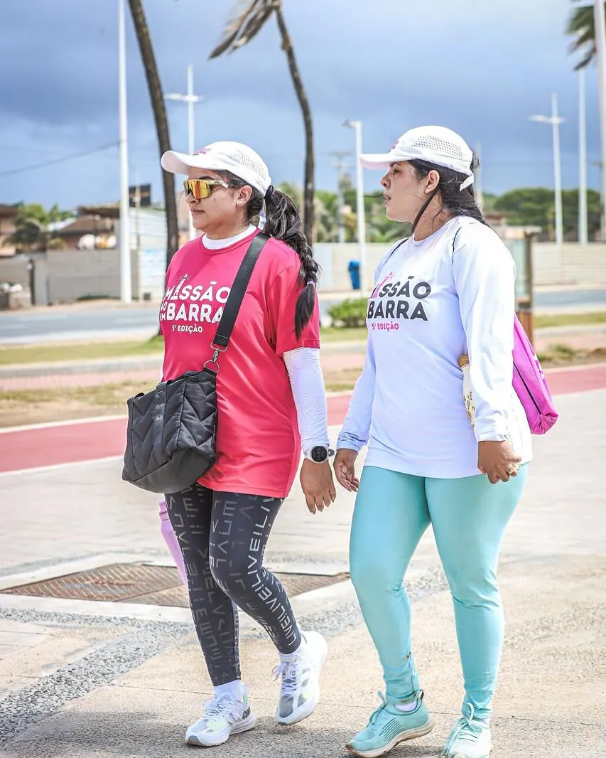 Duas participantes da 5ª edição caminhando lado a lado pela orla